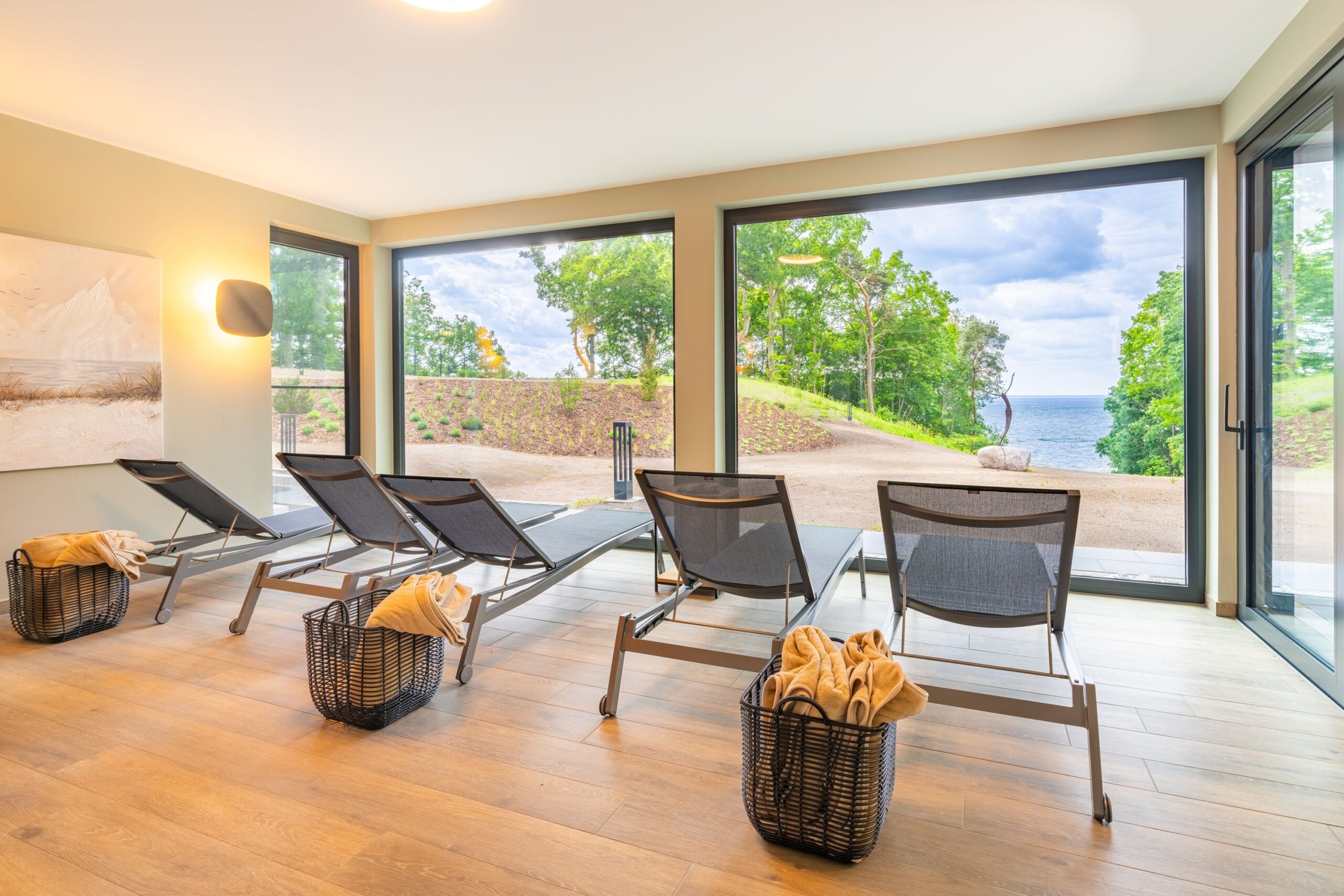 Ruhiger Innenbereich der Luxus-Ferienwohnungen DECK9 mit Liegen und Blick ins Grüne auf Usedom.